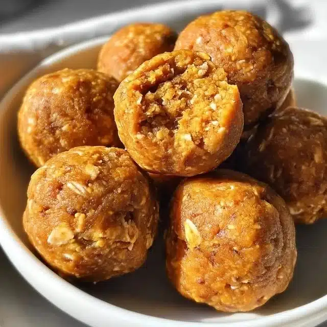 Homemade pumpkin protein balls on a plate with healthy ingredients