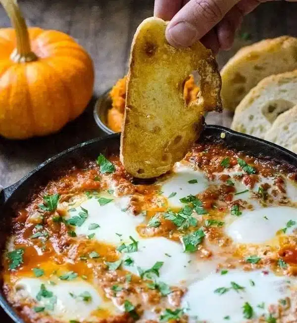 Delicious Pumpkin Shakshuka with baked eggs in a savory tomato stew