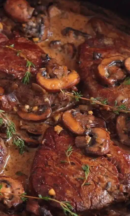 Delicious Filet Mignon served in a creamy sauce on a white plate