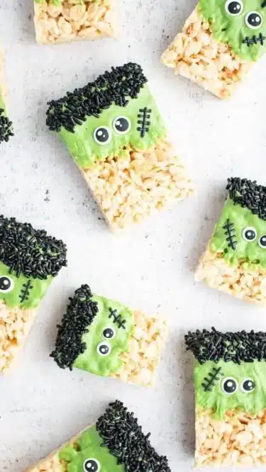Frankenstein Halloween Rice Krispie Treats decorated with green icing and candy features